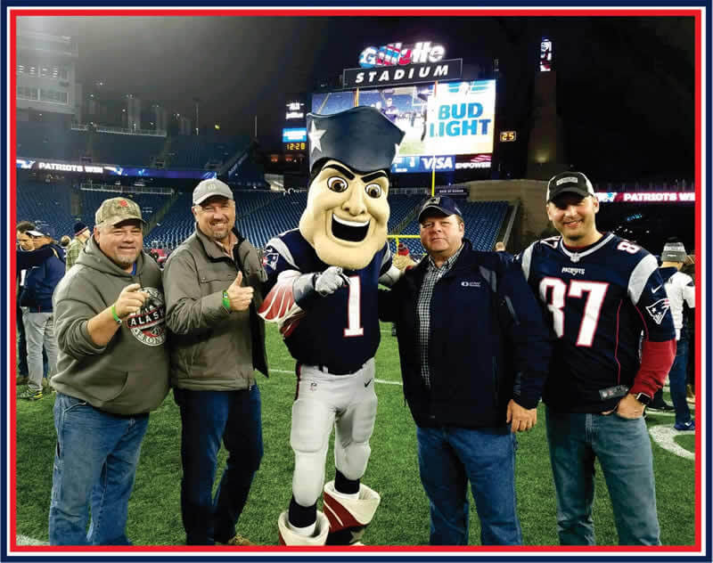 Sheridan team members with the Patriots' mascot.