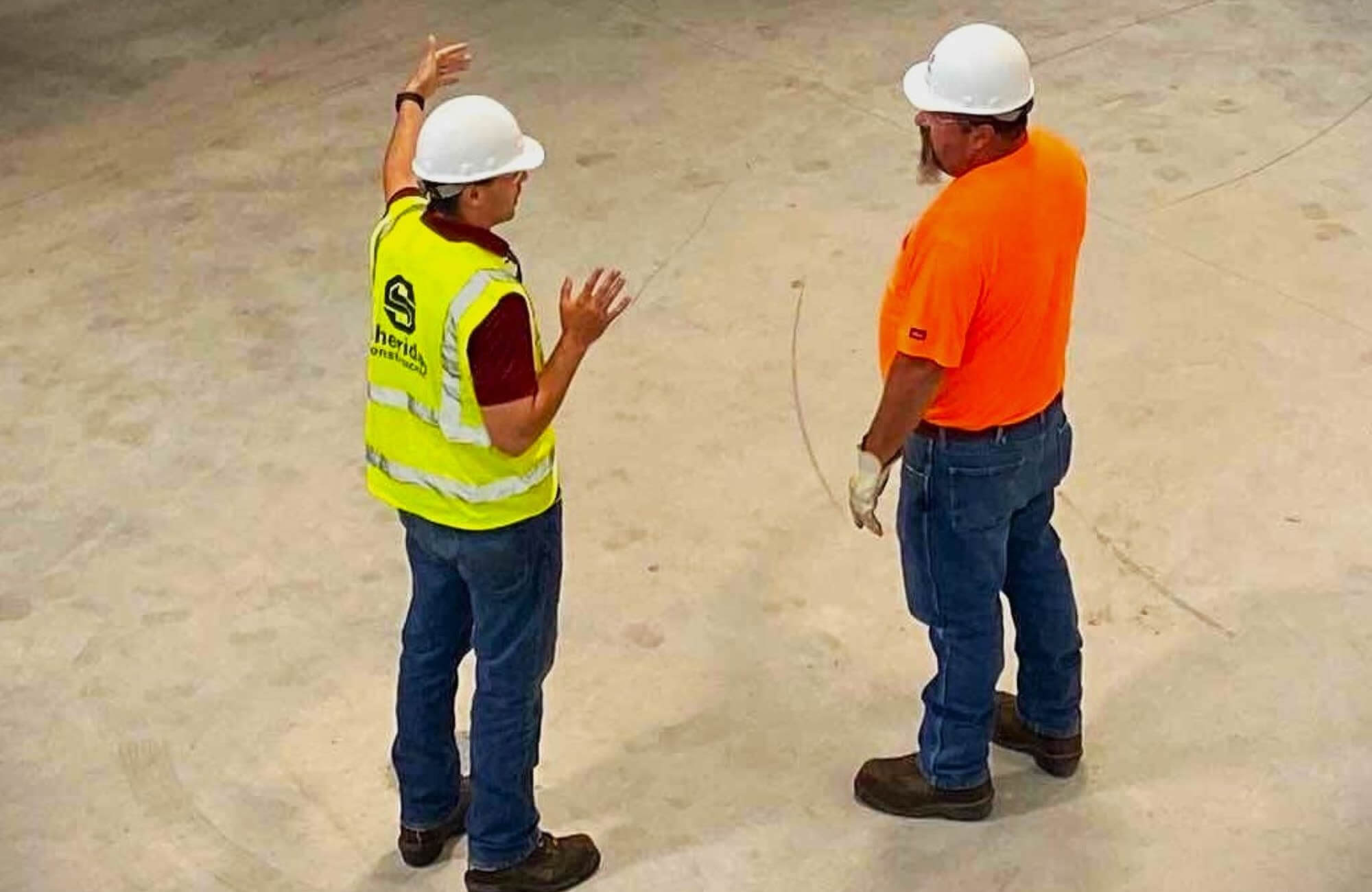 Two Sheridan Construction staff members discussing a project.