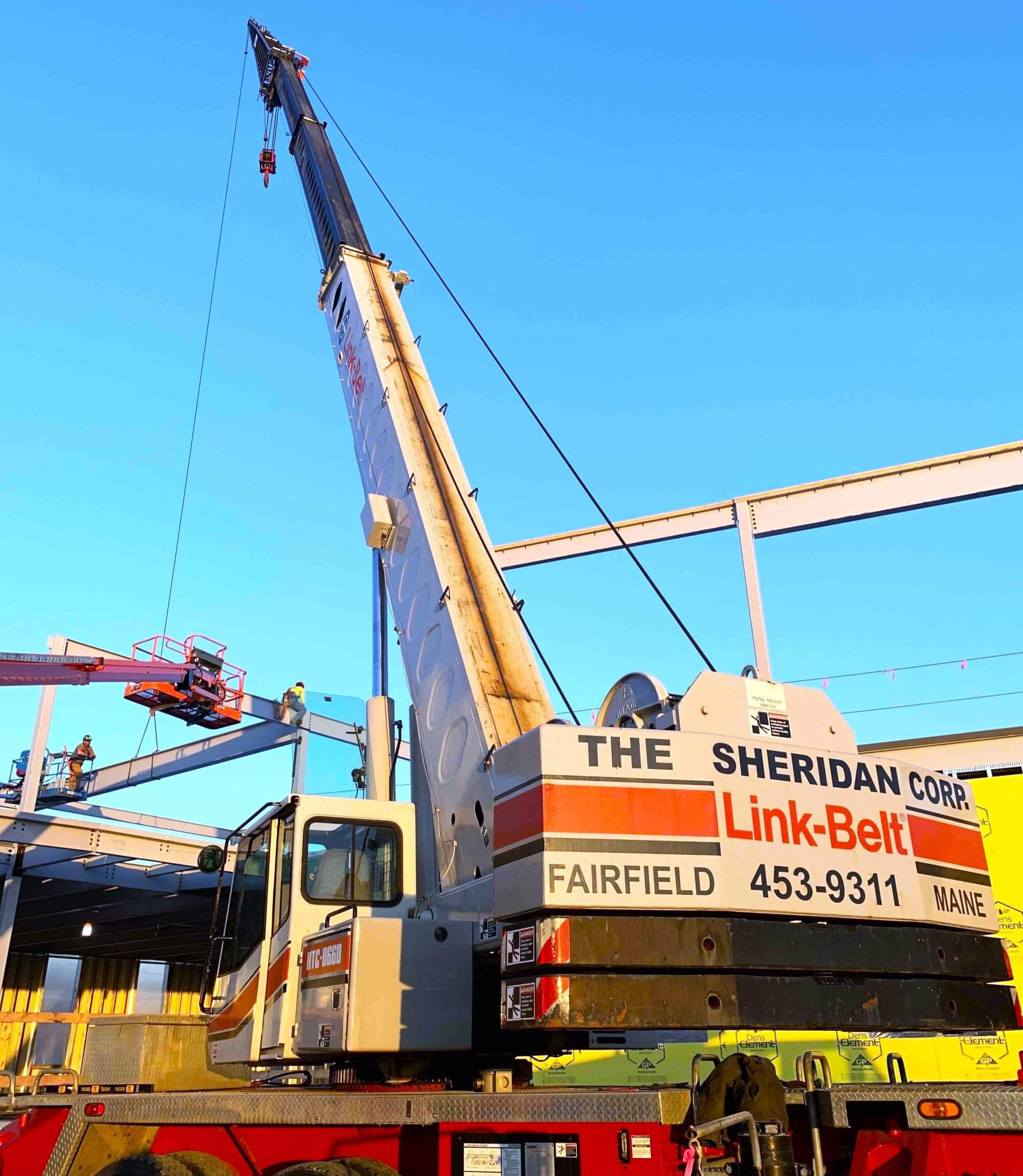 One of Sheridan Construction's cranes and crew erecting a steel frame building.