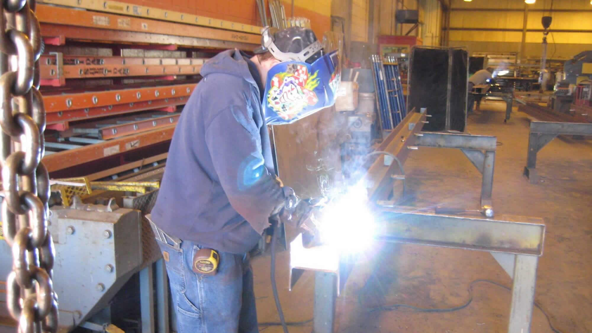 Sheridan team member fabricating steel.