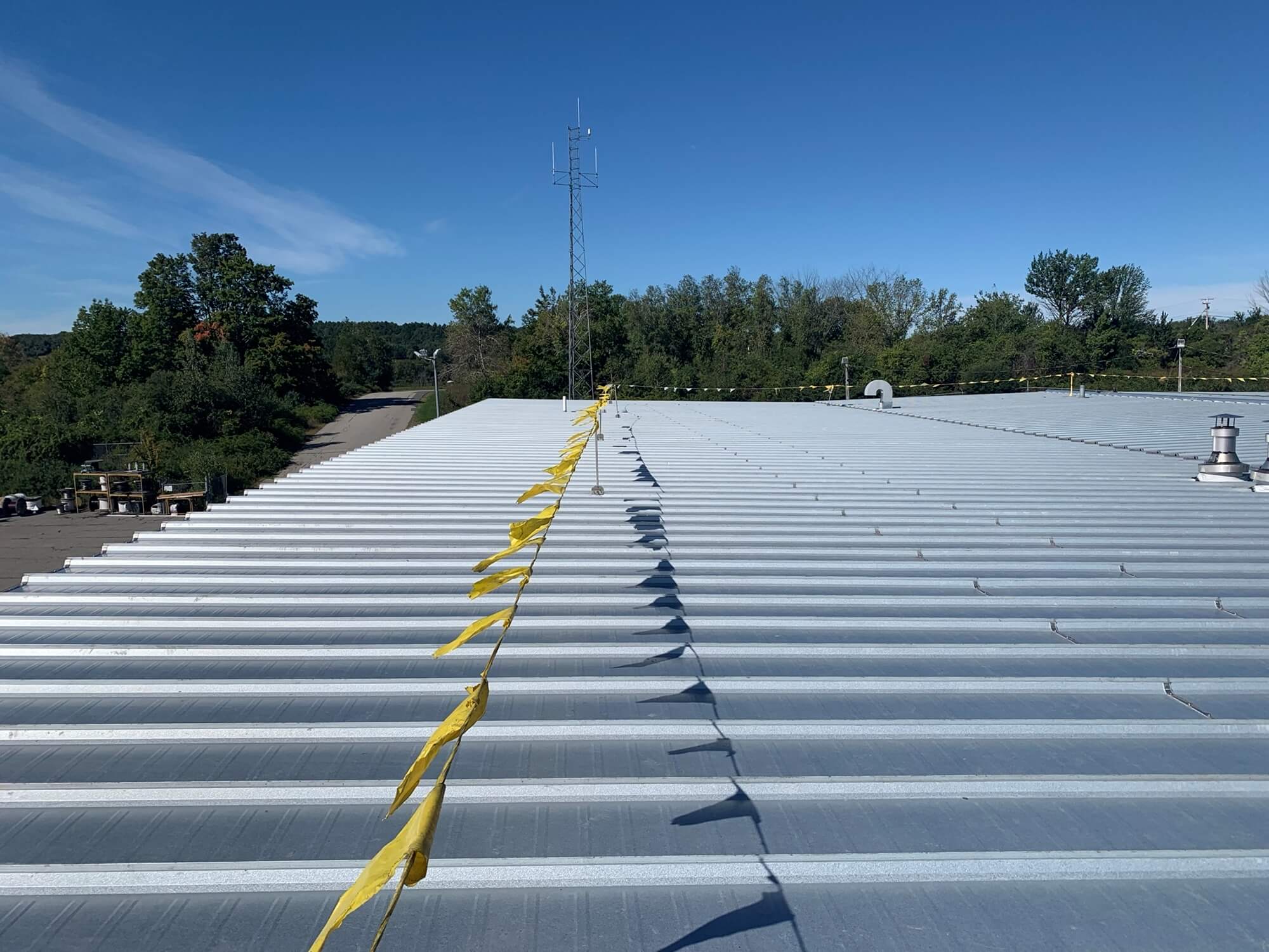 Metal roof with yellow flag barrier.